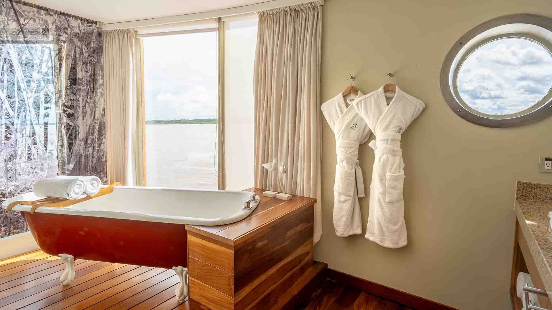 The Owner's Suite aboard the Delfin III, with floor-to-ceiling river views