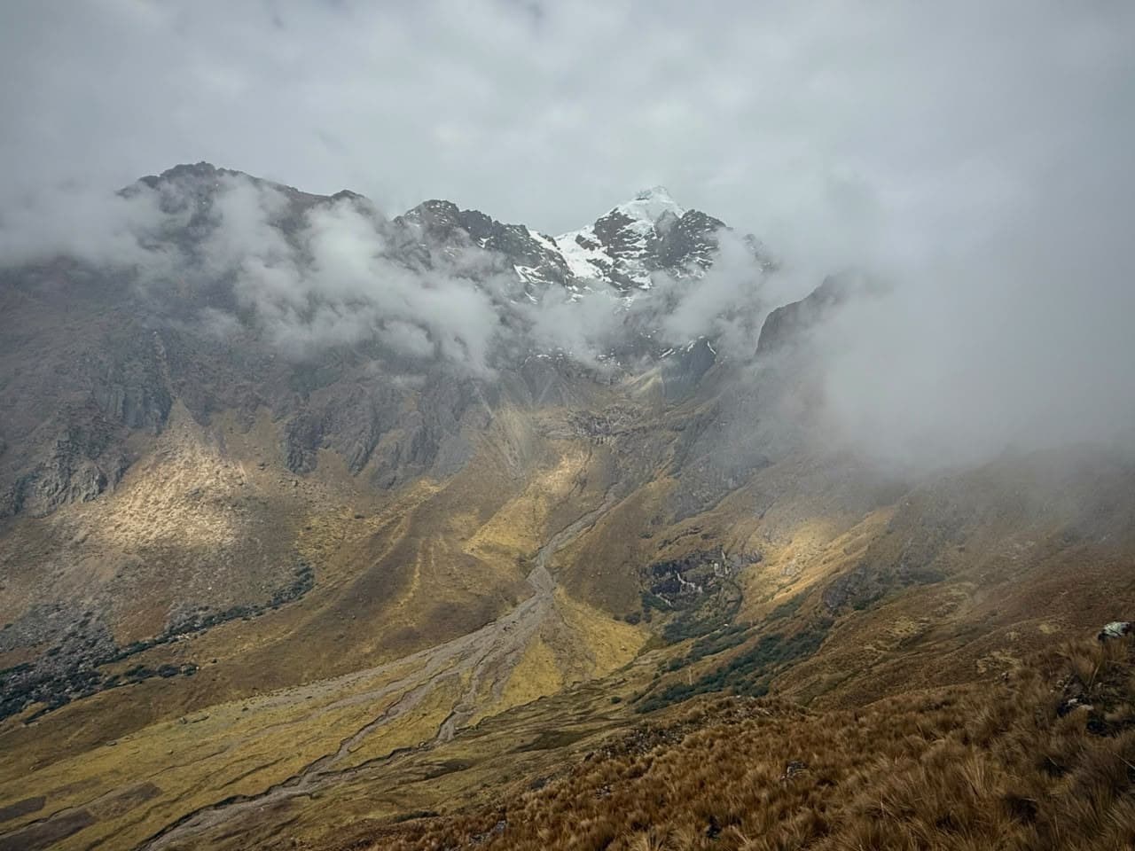 A snow peak breaking through cloud above the Abra Málaga pass, Cusco, Peru